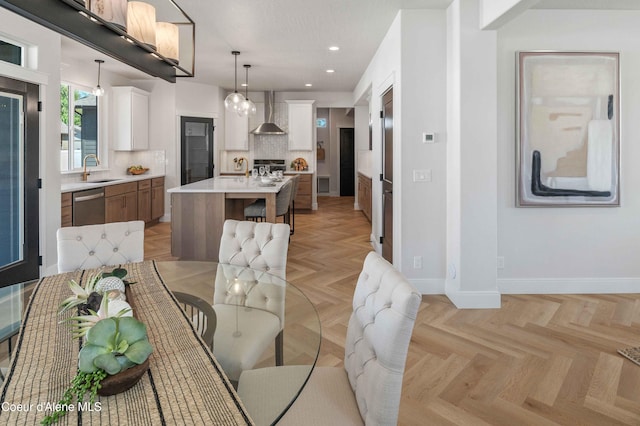 dining area featuring sink and light parquet flooring