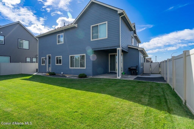 rear view of house featuring a patio and a lawn