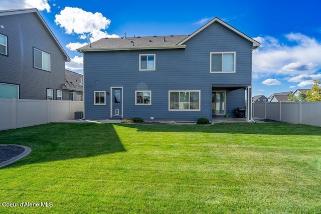 rear view of property with central AC unit, a patio, and a lawn