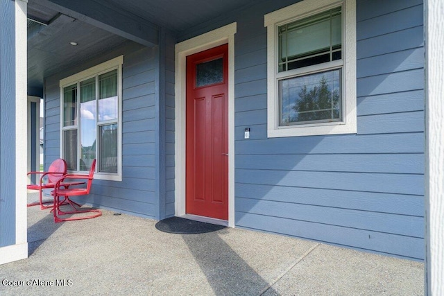 view of exterior entry with covered porch