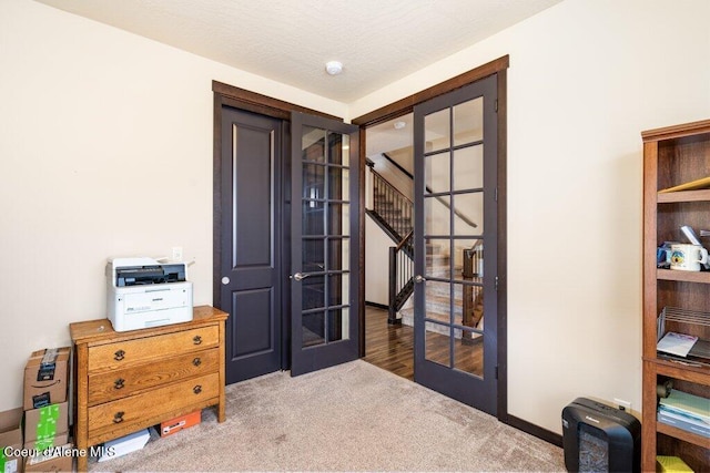 interior space with french doors and a textured ceiling