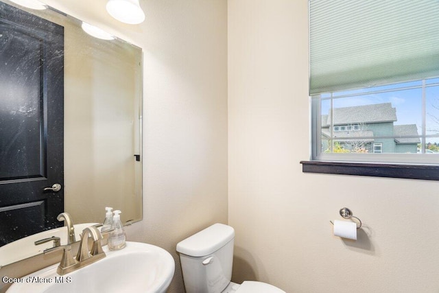 bathroom featuring toilet and sink