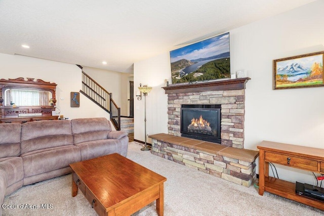 carpeted living room featuring a stone fireplace