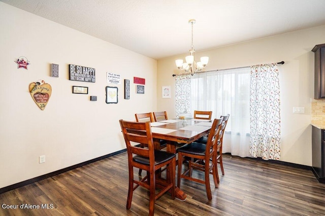 dining room featuring an inviting chandelier and dark wood-type flooring