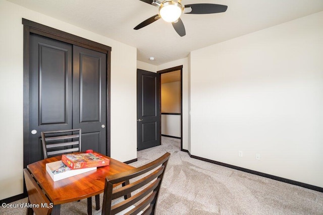 dining area featuring light carpet and ceiling fan