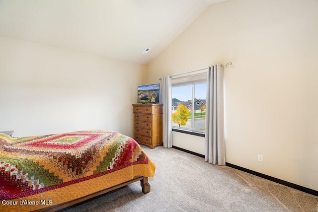 carpeted bedroom featuring high vaulted ceiling