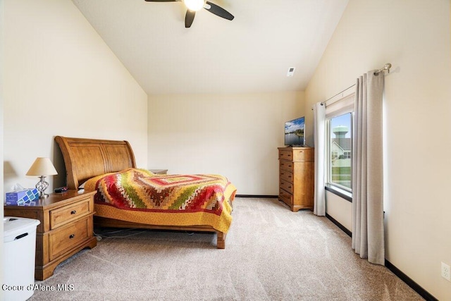 carpeted bedroom with ceiling fan and vaulted ceiling