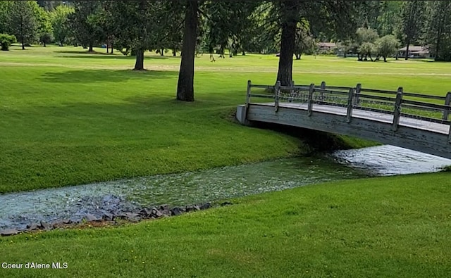 surrounding community with a lawn and fence