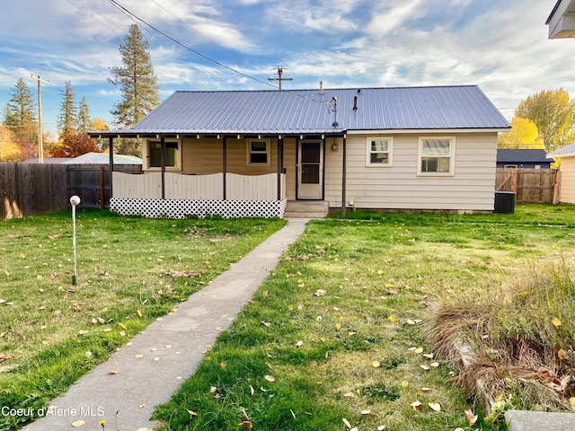 view of front of property featuring central AC and a front yard