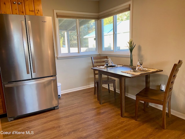 dining space with hardwood / wood-style flooring