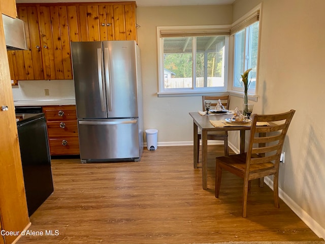 kitchen with stainless steel fridge, stove, and light hardwood / wood-style floors