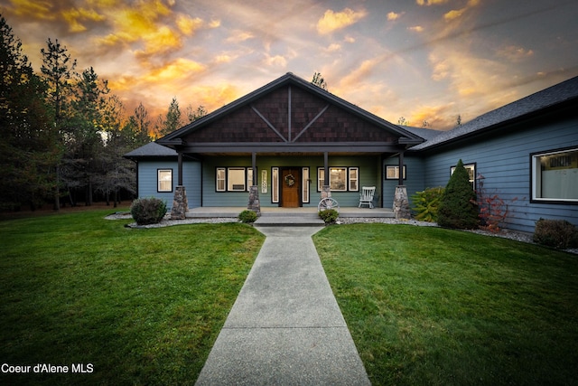 craftsman-style house with a yard and a porch