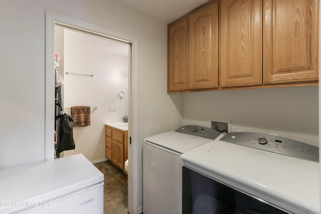 296 Ullr Dr, Sandpoint, ID 83864 - laundry room featuring cabinet space, baseboards, and washing machine and dryer