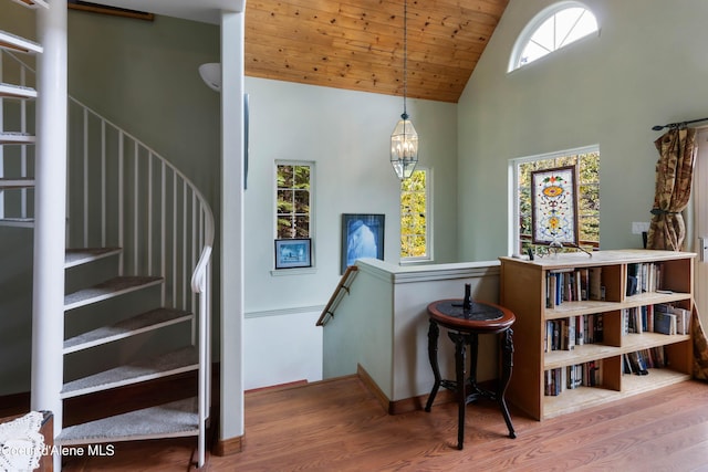 296 Ullr Dr, Sandpoint, ID 83864 - stairs featuring an inviting chandelier, wood finished floors, baseboards, high vaulted ceiling, and wooden ceiling
