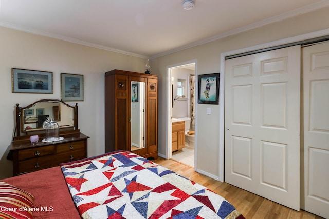 296 Ullr Dr, Sandpoint, ID 83864 - bedroom with a closet, ornamental molding, baseboards, ensuite bathroom, and light wood-type flooring