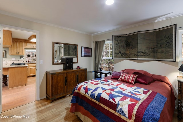 296 Ullr Dr, Sandpoint, ID 83864 - bedroom featuring ornamental molding and light wood finished floors