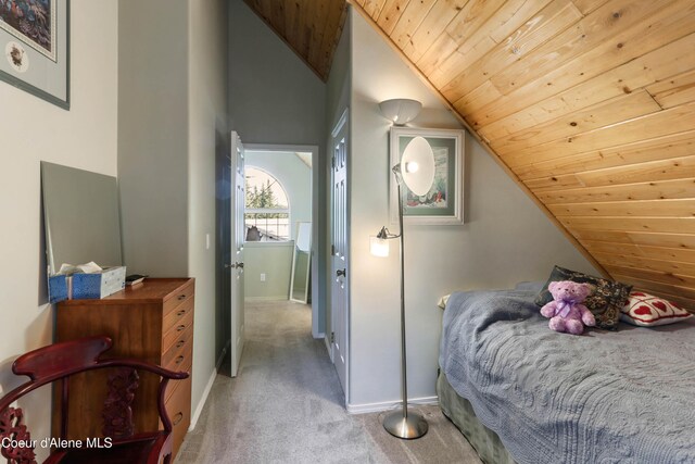 296 Ullr Dr, Sandpoint, ID 83864 - bedroom with carpet floors, baseboards, wood ceiling, and lofted ceiling