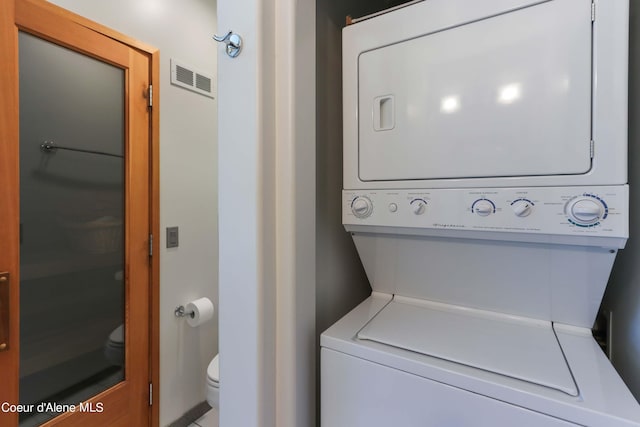 laundry area with stacked washer / dryer