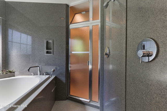 bathroom featuring separate shower and tub