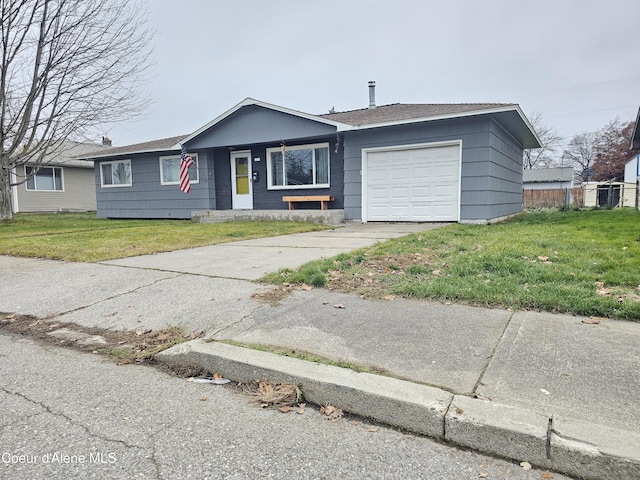 ranch-style house with a garage and a front lawn