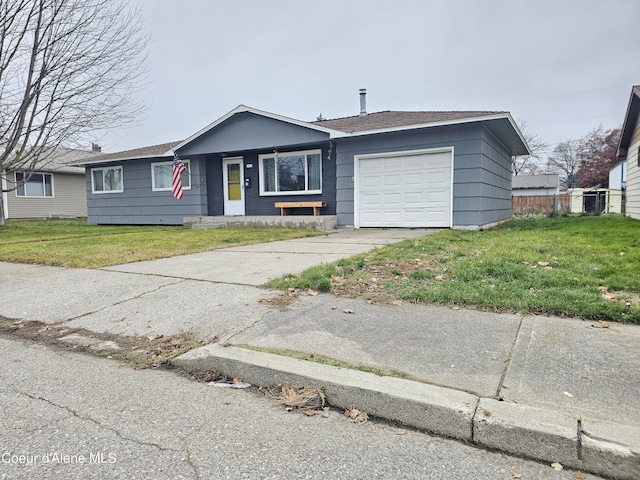 ranch-style house featuring a garage and a front lawn