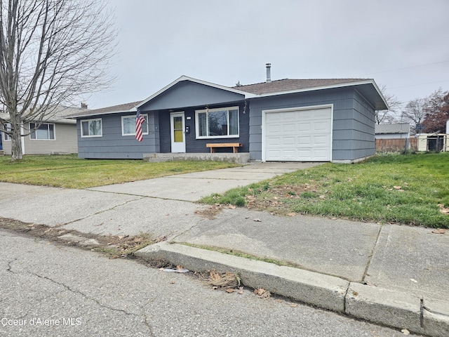 ranch-style house featuring a front yard and a garage