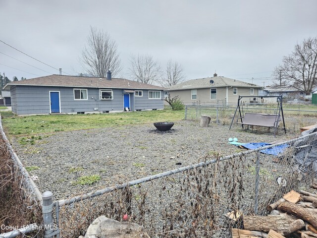 back of house featuring a yard