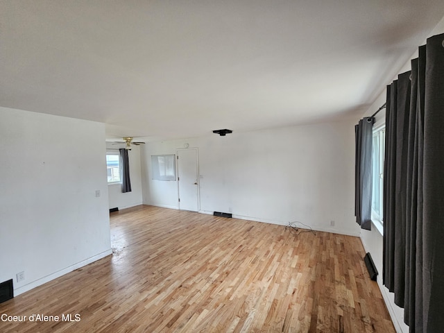 unfurnished room with ceiling fan and light hardwood / wood-style flooring