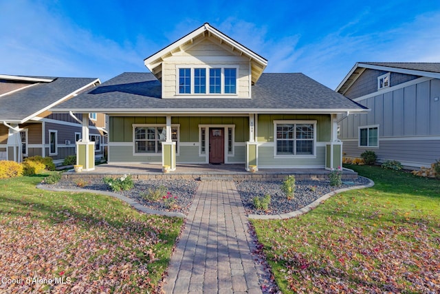 view of front of home with a porch and a front lawn