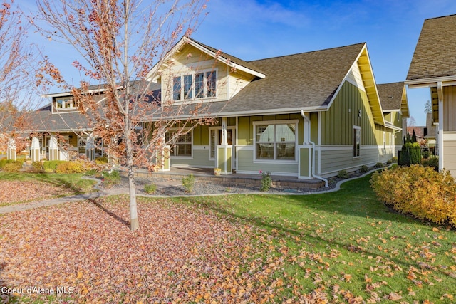 view of front of home featuring a front yard and covered porch