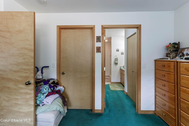 bedroom featuring connected bathroom and dark carpet