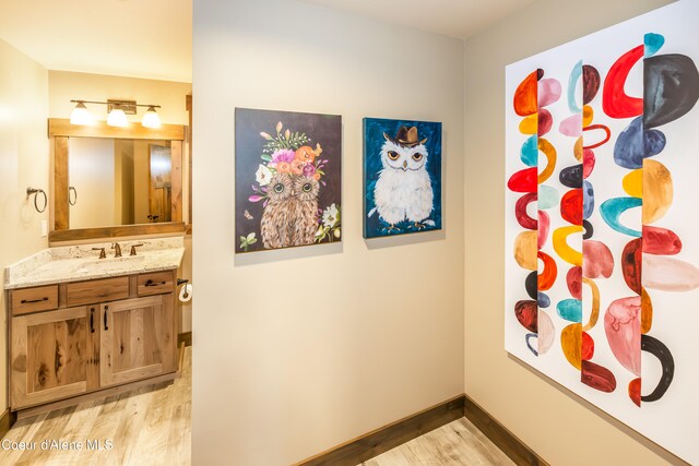 interior space with vanity and hardwood / wood-style flooring