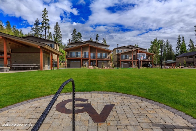 rear view of property featuring a lawn and a patio