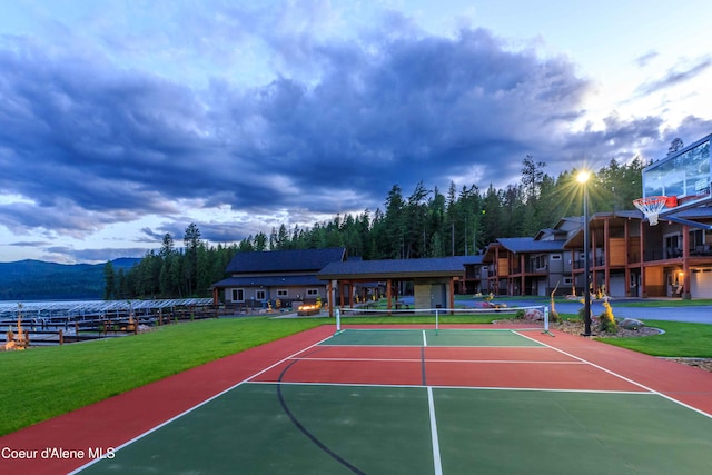 view of sport court with a mountain view, a yard, and basketball court