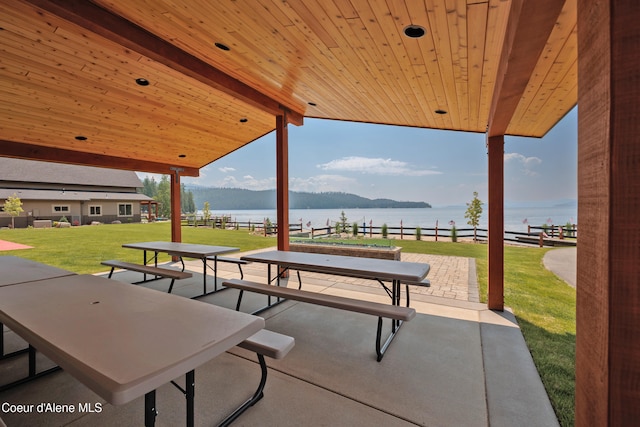 view of patio with a water and mountain view