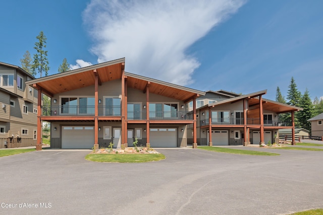 view of front of property with a balcony and a garage