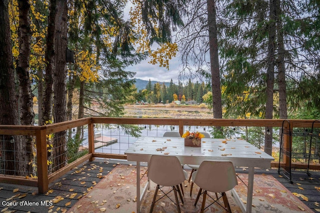 deck with a patio area and a water view