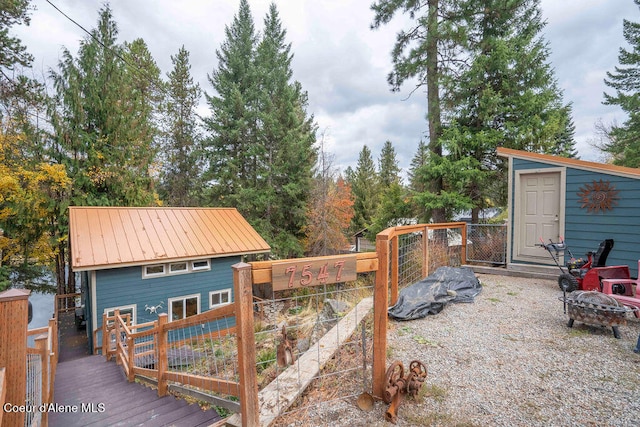 wooden terrace featuring an outbuilding