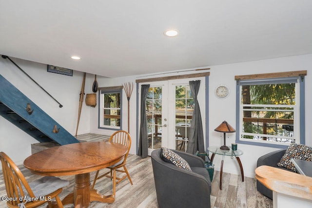 dining area with light hardwood / wood-style flooring and french doors