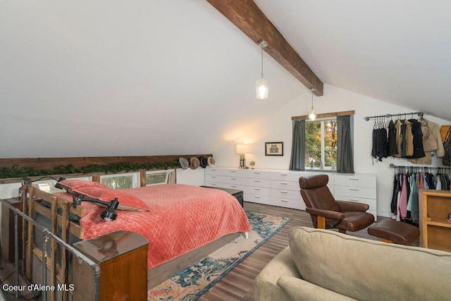 bedroom with lofted ceiling with beams and hardwood / wood-style flooring