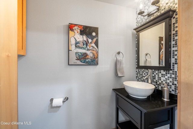 bathroom with vanity and tasteful backsplash