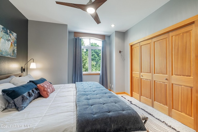 bedroom with ceiling fan and a closet