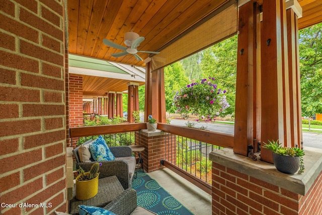 sunroom with ceiling fan and wooden ceiling