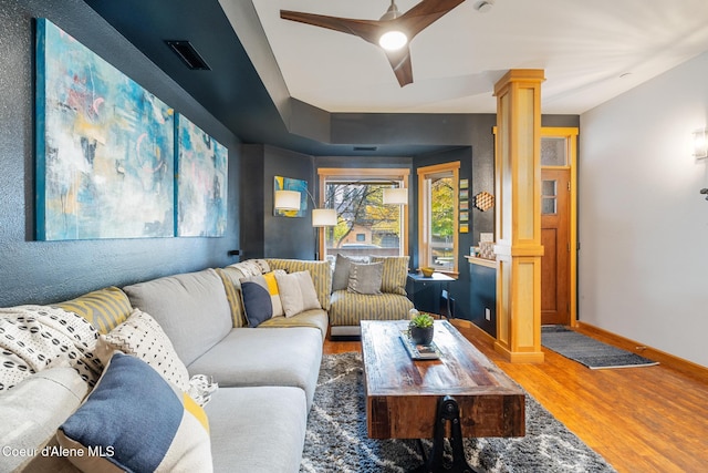 living room featuring ornate columns and hardwood / wood-style flooring