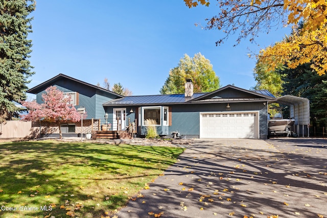 split level home with covered porch, a carport, a front lawn, and a garage