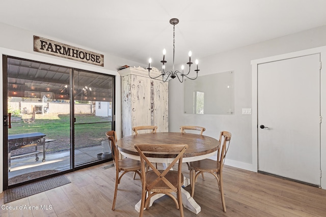 dining room featuring an inviting chandelier and light wood-type flooring