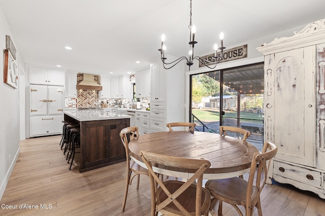 dining room featuring light hardwood / wood-style flooring and a chandelier