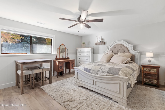 bedroom with light hardwood / wood-style floors and ceiling fan