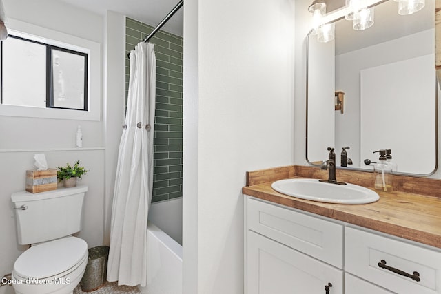 full bathroom with vanity, shower / tub combo, and toilet