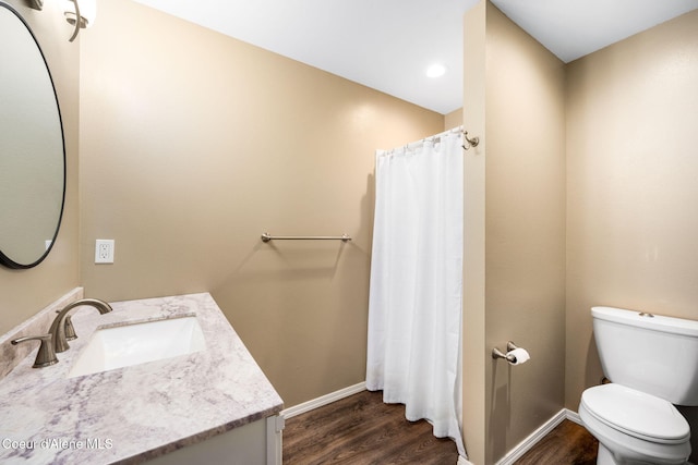 bathroom featuring vanity, hardwood / wood-style flooring, and toilet